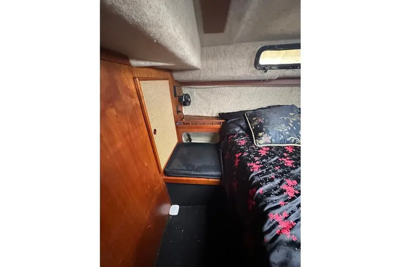 Slide: The Image of 1982 S 2 9.2C yacht interior with wooden cabinetry and floral bedding. - 2