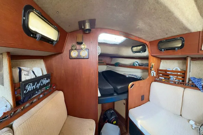 Slide: The Image of Interior of 1982 S 2 9.2C sailboat with cozy seating and nautical decor. - 4