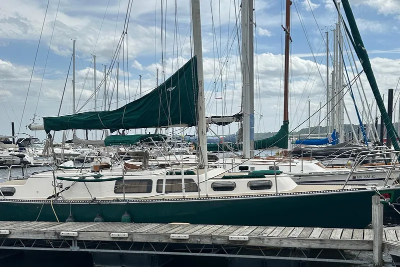 Slide: The Image of 1982 S 2 9.2C sailboat docked at marina with green sail cover. - 6