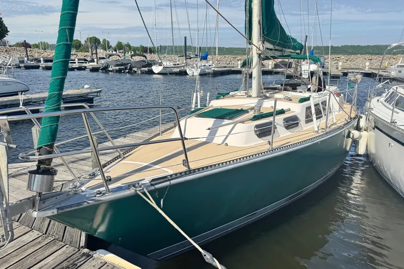 Slide: The Image of 1982 S 2 9.2C sailboat docked at marina with green sail cover. - 8