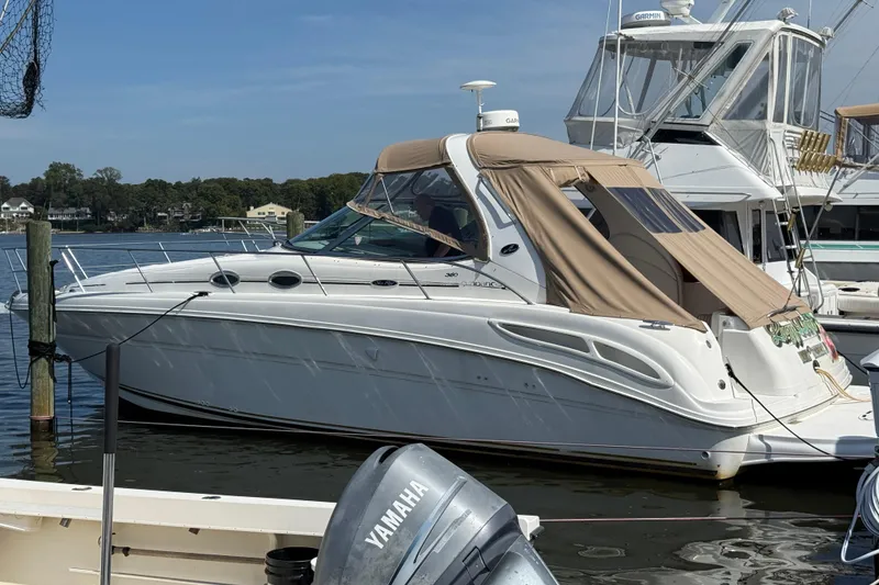 The Image of 2002 Sea Ray 360 Sundancer yacht docked at marina with beige canopy. - 0