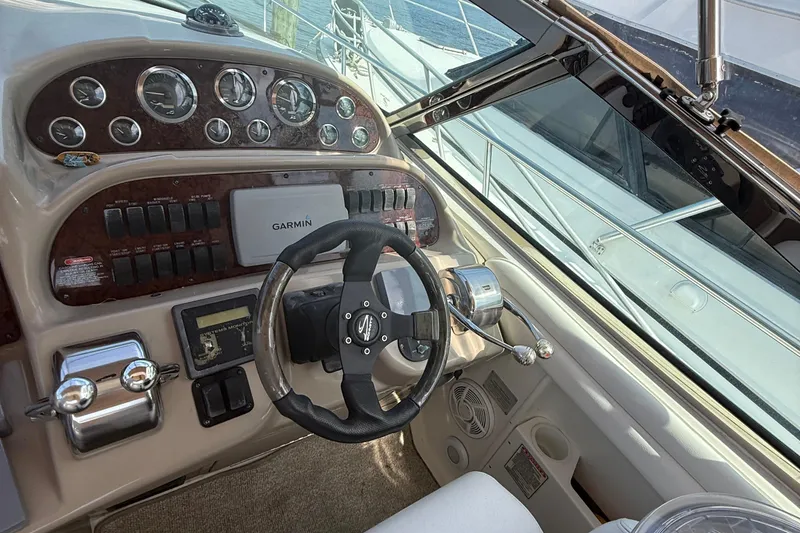 Slide: The Image of Helm of 2002 Sea Ray 360 Sundancer with Garmin navigation system and classic controls. - 10