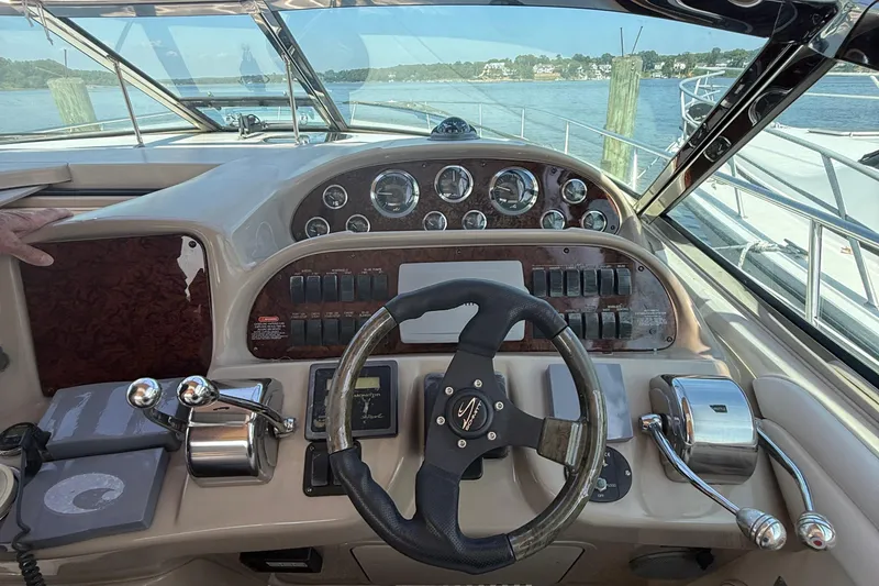 Slide: The Image of Cockpit view of a 2002 Sea Ray 360 Sundancer, featuring steering wheel and control panel. - 11