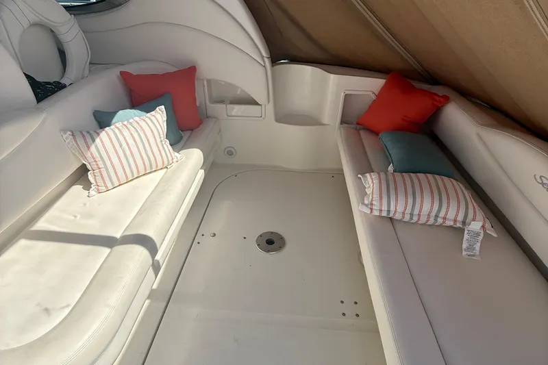 Slide: The Image of Interior of 2002 Sea Ray 360 Sundancer with white seating and colorful cushions. - 12