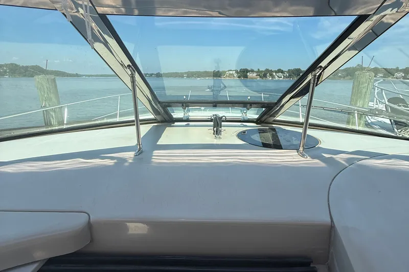 Slide: The Image of 2002 Sea Ray 360 Sundancer cockpit view with clear skies and calm waters. - 14