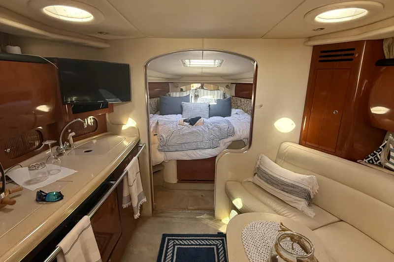 Slide: The Image of Luxurious interior of 2002 Sea Ray 360 Sundancer yacht with cozy bedroom and kitchenette. - 15