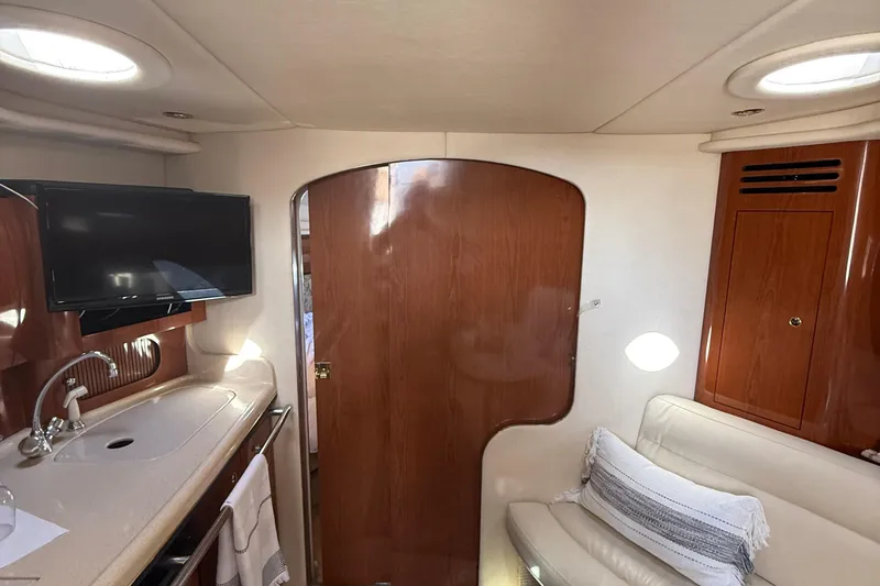 Slide: The Image of 2002 Sea Ray 360 Sundancer cabin interior with TV, sink, and seating area. - 16