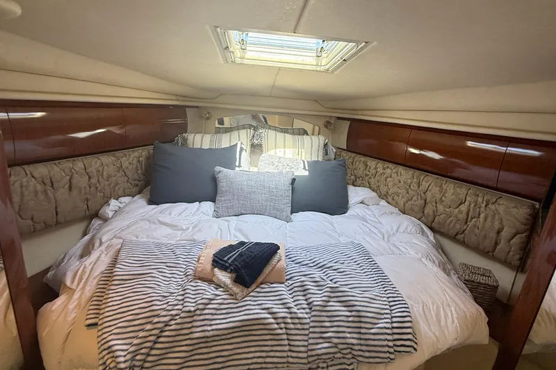 Slide: The Image of Luxurious cabin interior of 2002 Sea Ray 360 Sundancer with cozy bedding and skylight. - 17