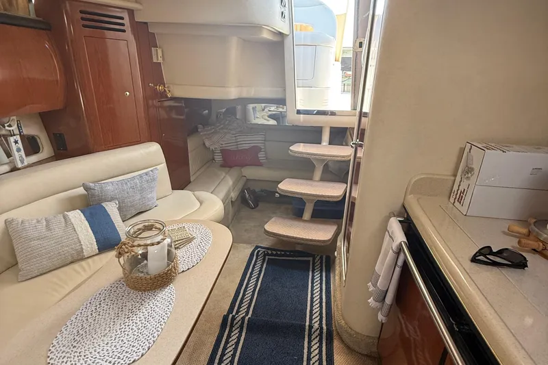 Slide: The Image of Interior of 2002 Sea Ray 360 Sundancer yacht with cozy seating and elegant decor. - 18