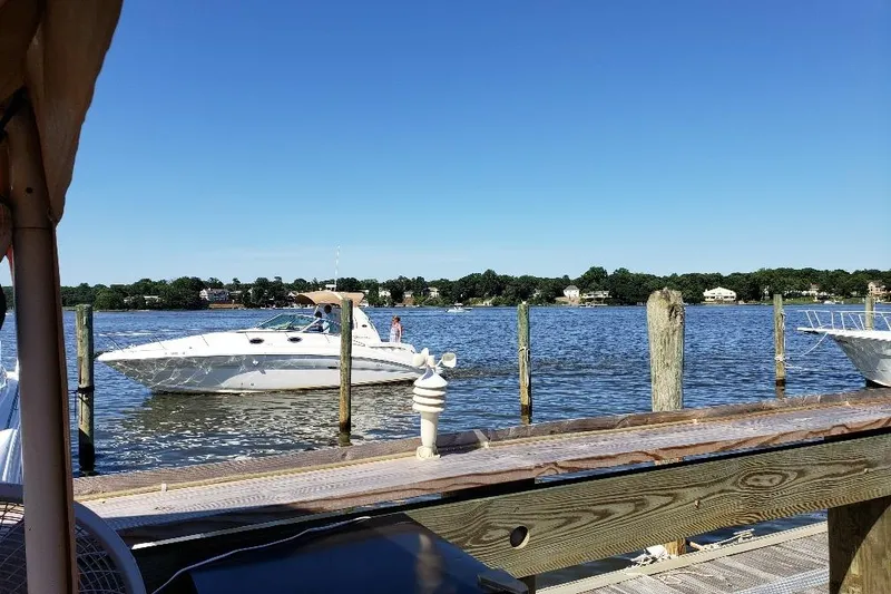 Slide: The Image of 2002 Sea Ray 360 Sundancer boat docked on a sunny day by the lake. - 2