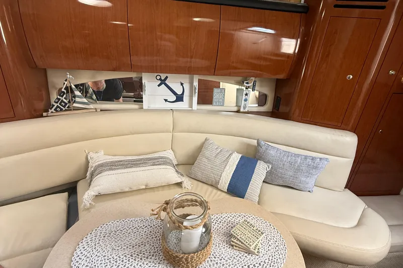 Slide: The Image of Interior of 2002 Sea Ray 360 Sundancer with cozy seating and nautical decor. - 20