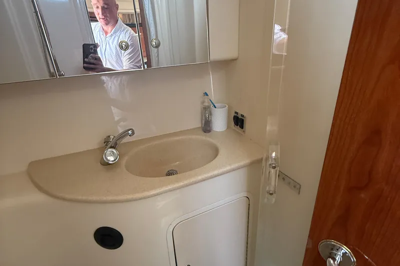 Slide: The Image of 2002 Sea Ray 360 Sundancer bathroom with sink, mirror, and toiletries. - 25