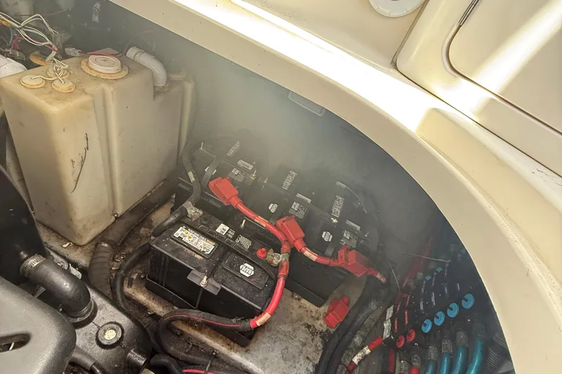 Slide: The Image of Engine compartment of a 2002 Sea Ray 360 Sundancer with batteries and wiring. - 34