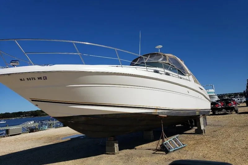 Slide: The Image of 2002 Sea Ray 360 Sundancer yacht on dry dock under clear blue sky. - 4