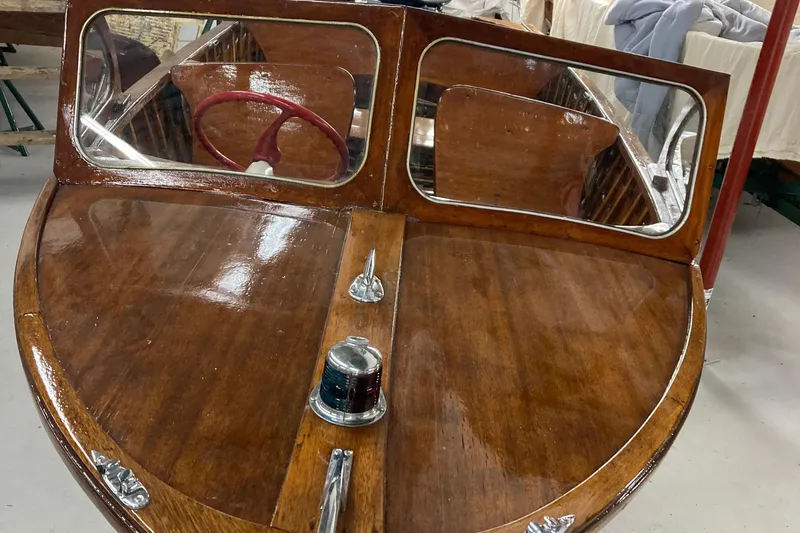 Slide: The Image of 1954 Lyman outboard boat with polished wood finish and dual windshields. - 1