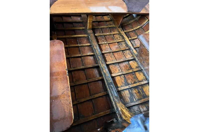 Slide: The Image of 1954 Lyman outboard boat interior with wooden floor and seating. - 10