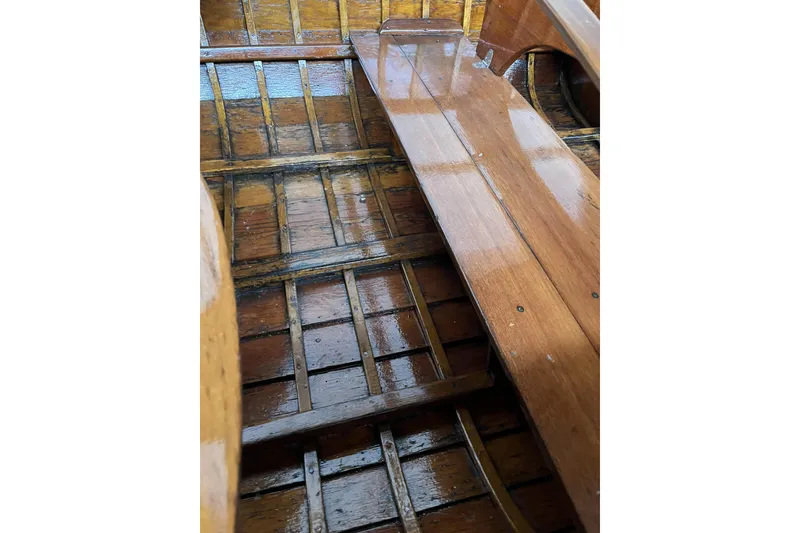 Slide: The Image of 1954 Lyman outboard boat interior with polished wooden seats and floor. - 12