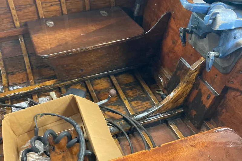 Slide: The Image of 1954 Lyman outboard boat interior with wooden seats and vintage equipment. - 4