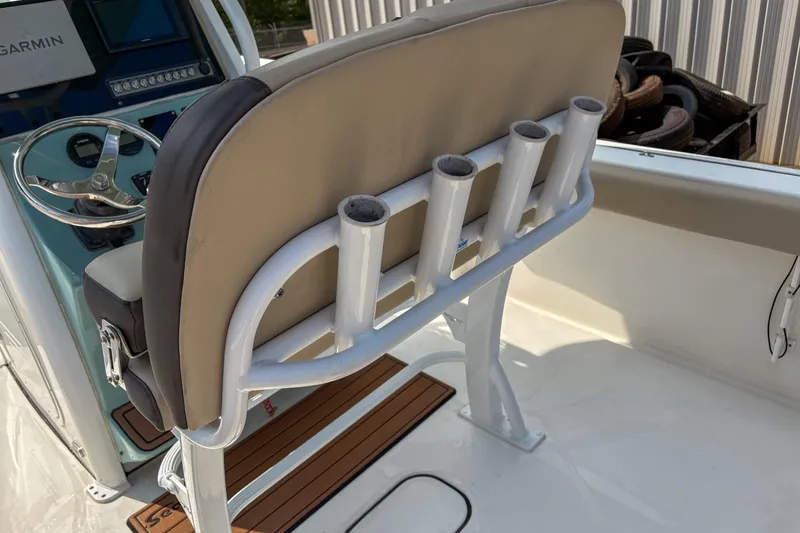 Slide: The Image of 2020 Tidewater 232 CC Adventure boat helm with rod holders and Garmin display. - 7