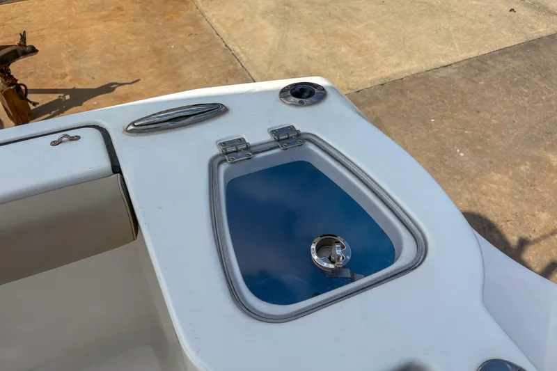 Slide: The Image of 2020 Tidewater 232 CC Adventure boat deck with storage compartment and latch. - 8