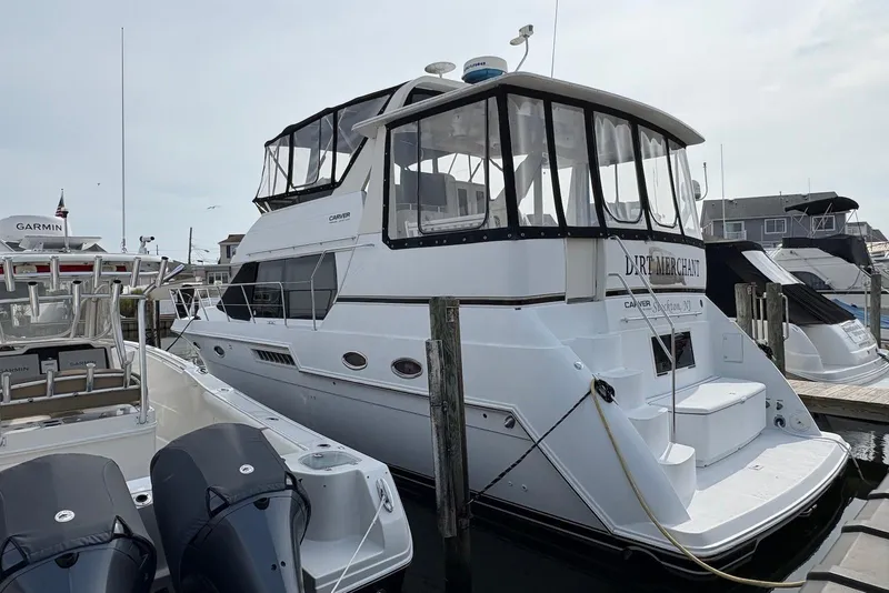 The Image of 2002 Carver 406 Aft Cabin Motor Yacht docked at marina, rear view. - 0