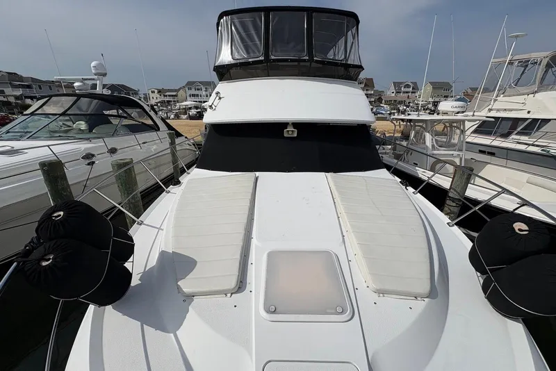 Slide: The Image of 2002 Carver 406 Aft Cabin Motor Yacht docked at marina, front view. - 11