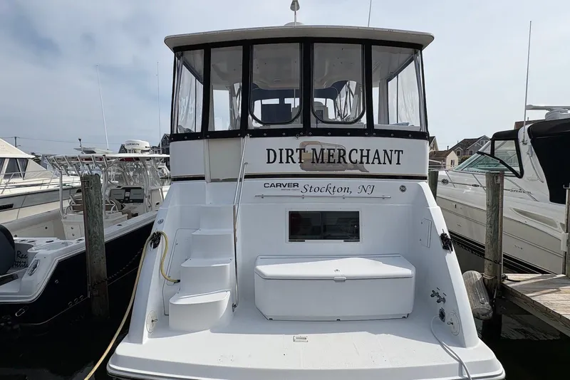 Slide: The Image of 2002 Carver 406 Aft Cabin Motor Yacht docked, named "Dirt Merchant," located in Stockton, NJ. - 2