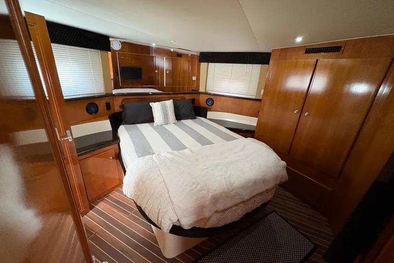 Slide: The Image of Luxurious bedroom interior of 2002 Carver 406 Aft Cabin Motor Yacht with wood paneling. - 24