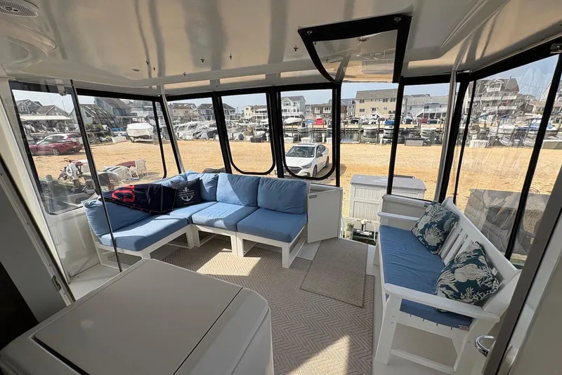 Slide: The Image of Spacious interior of 2002 Carver 406 Aft Cabin Motor Yacht with blue seating and large windows. - 4