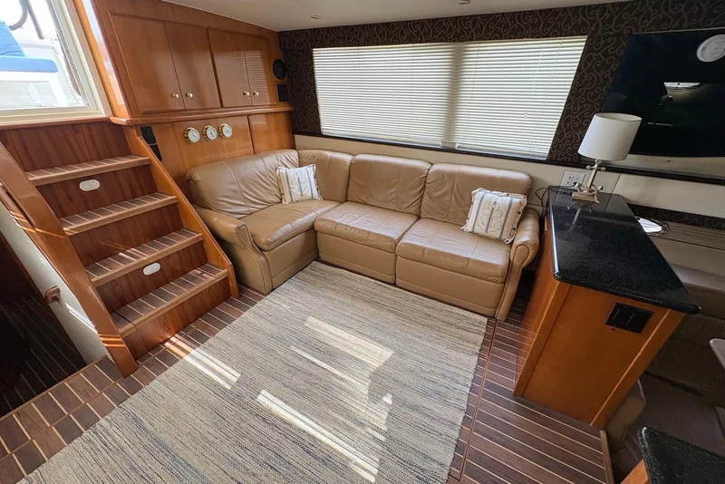 Slide: The Image of Luxurious interior of 2002 Carver 406 Aft Cabin Motor Yacht with leather sofa and wooden accents. - 14