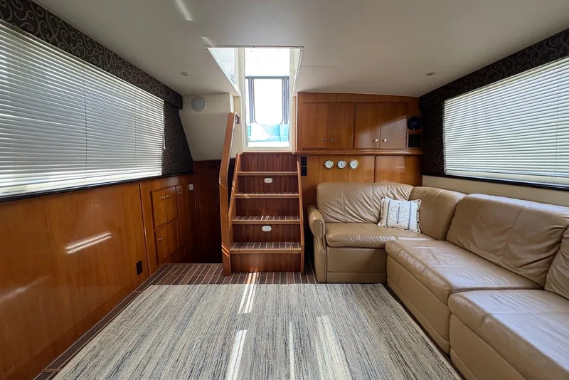 Slide: The Image of Interior of 2002 Carver 406 Aft Cabin Motor Yacht with leather seating and wooden cabinetry. - 16