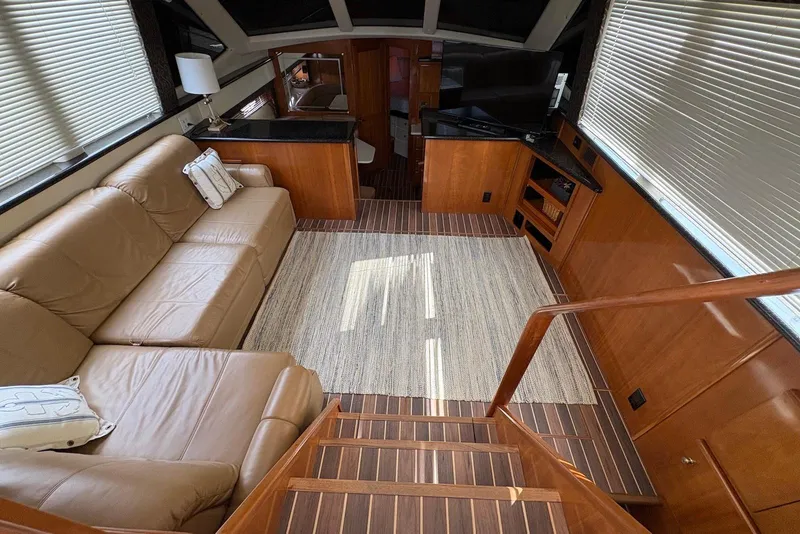 Slide: The Image of Luxurious interior of 2002 Carver 406 Aft Cabin Motor Yacht with leather seating and wood finishes. - 17