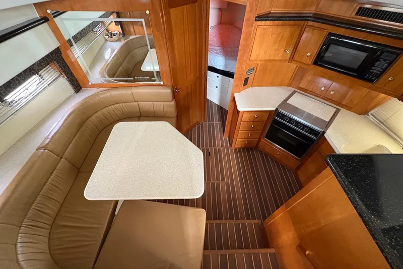 Slide: The Image of Interior of 2002 Carver 406 Aft Cabin Motor Yacht with kitchen and seating area. - 18