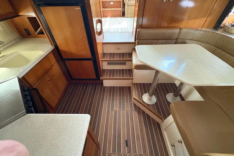 Slide: The Image of Interior of 2002 Carver 406 Aft Cabin Motor Yacht with dining area and kitchenette. - 21