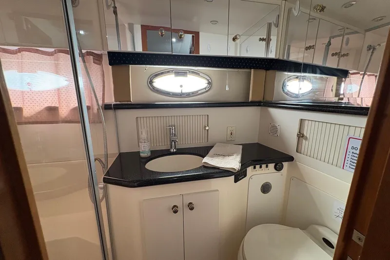 Slide: The Image of Luxurious bathroom in 2002 Carver 406 Aft Cabin Motor Yacht with elegant fixtures and ample storage. - 26