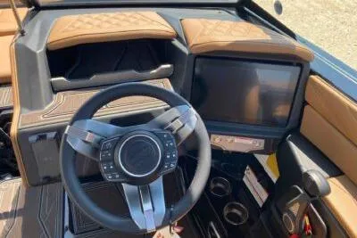 Slide: The Image of 2026 Tigé 24RZX boat dashboard with modern steering wheel and touchscreen display. - 7