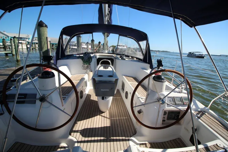 Slide: The Image of 2005 Jeanneau Sun Odyssey 40.3 sailboat cockpit with dual steering wheels, docked at marina. - 16