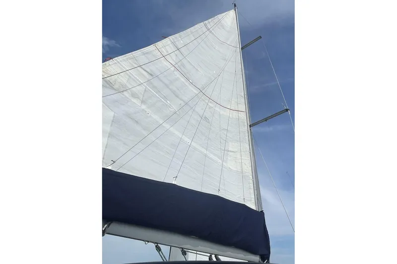 Slide: The Image of Sail of 2005 Jeanneau Sun Odyssey 40.3 yacht against a clear blue sky. - 20
