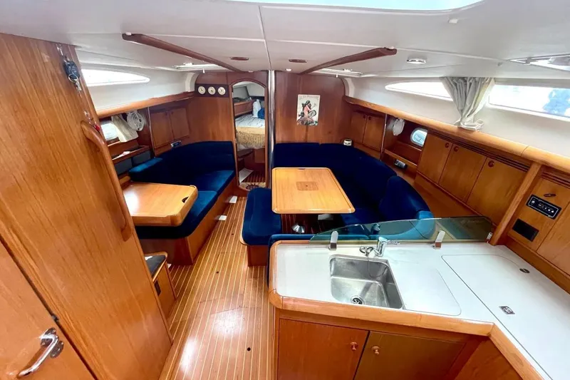 Slide: The Image of Interior of 2005 Jeanneau Sun Odyssey 40.3 yacht with wood finish and blue seating. - 21