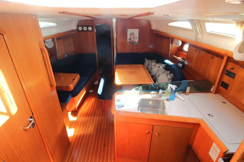 Slide: The Image of Interior of 2005 Jeanneau Sun Odyssey 40.3 sailboat with wood finish and cozy seating area. - 25