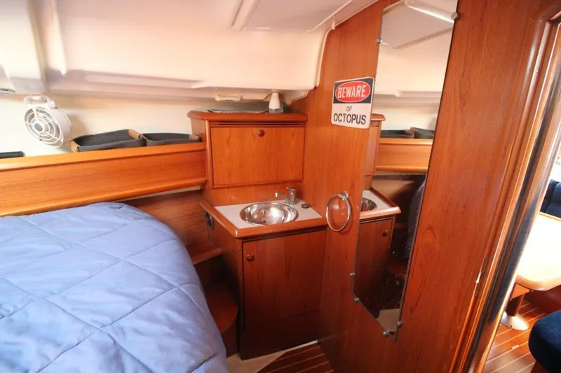 Slide: The Image of Cozy cabin interior of 2005 Jeanneau Sun Odyssey 40.3 with wood finish and compact sink. - 31