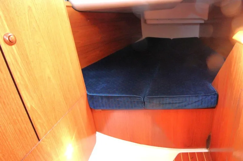 Slide: The Image of 2005 Jeanneau Sun Odyssey 40.3 cabin interior with blue cushions and wooden finish. - 32