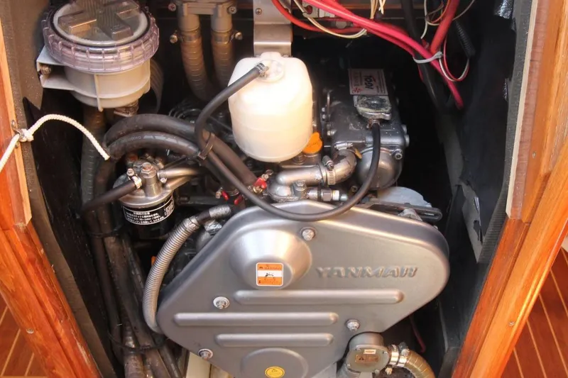 Slide: The Image of Engine compartment of a 2005 Jeanneau Sun Odyssey 40.3 sailboat, featuring a Yanmar engine. - 34