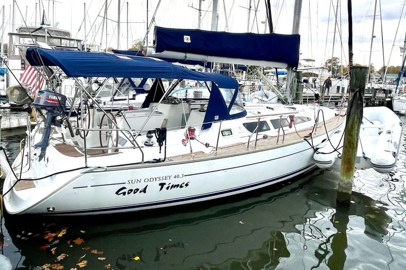 Slide: The Image of Jeanneau Sun Odyssey 40.3 sailboat docked, 2005 model, with blue canopy and sleek design. - 4