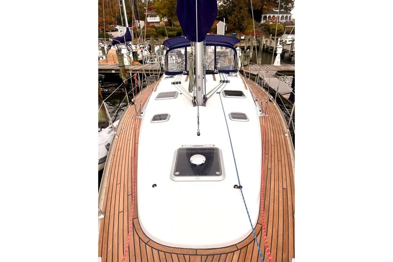 Slide: The Image of Cockpit of 2005 Jeanneau Sun Odyssey 40.3 with striped seating and wooden deck. - 8