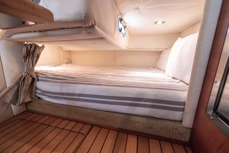 Slide: The Image of Luxurious cabin interior of 2007 Chris Craft Corsair with cozy bed and elegant wood flooring. - 15