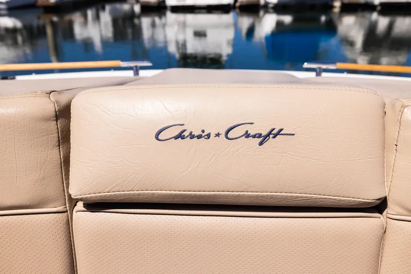 Slide: The Image of 2007 Chris Craft Corsair boat seat with logo, docked by the water. - 9
