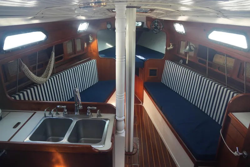 Slide: The Image of Interior of 1987 Ericson 32-200 sailboat with striped seating and dual sinks. - 12