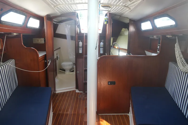 Slide: The Image of Interior of 1987 Ericson 32-200 sailboat with wood finish and striped seating. - 14