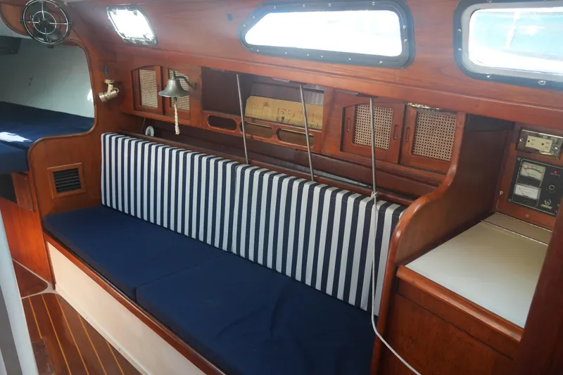 Slide: The Image of Interior of 1987 Ericson 32-200 sailboat with striped seating and wooden cabinetry. - 15